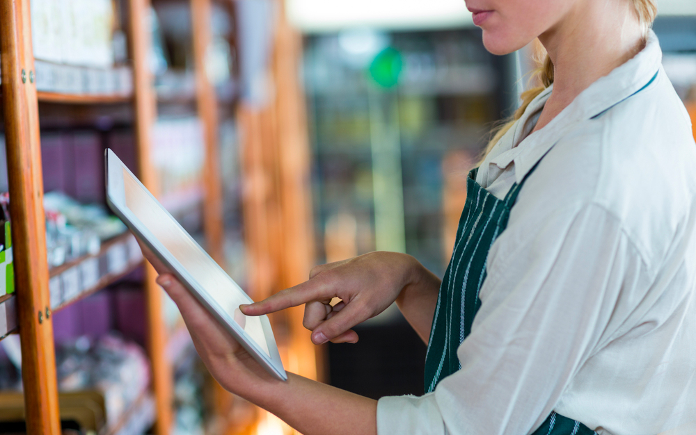 Female staff member in a supermarket with a tablet